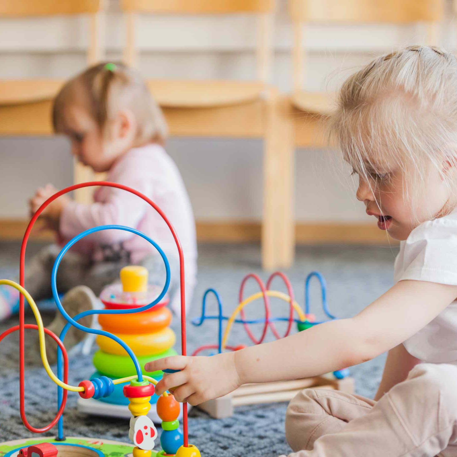 Niña pequeña jugando en nuestro gabinete de psicología infantil y adolescente en Los Remedios mientras una psicóloga la observa y analiza cómo ayudarla
